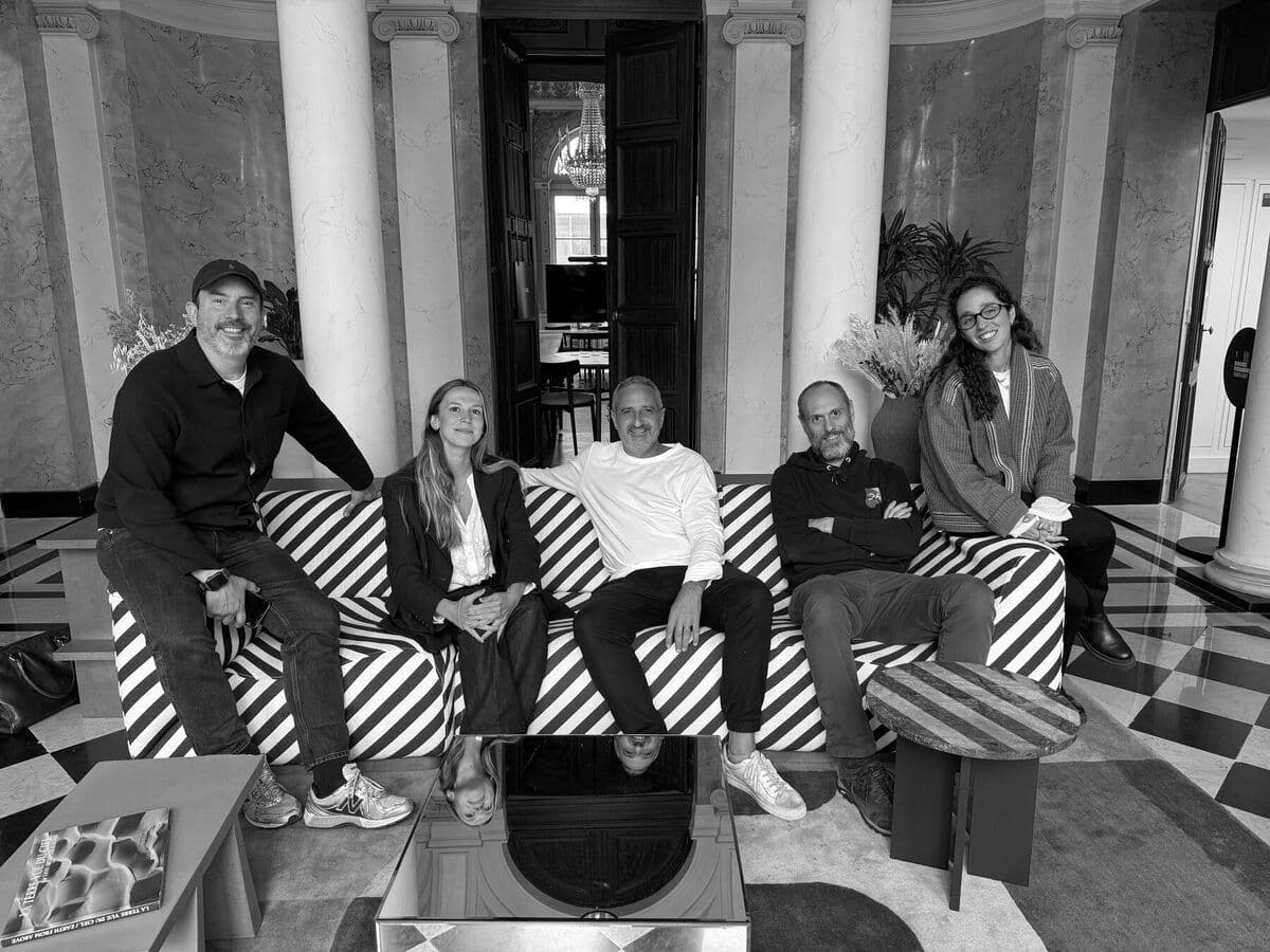 Five members of the 26lights team seated together in a lounge